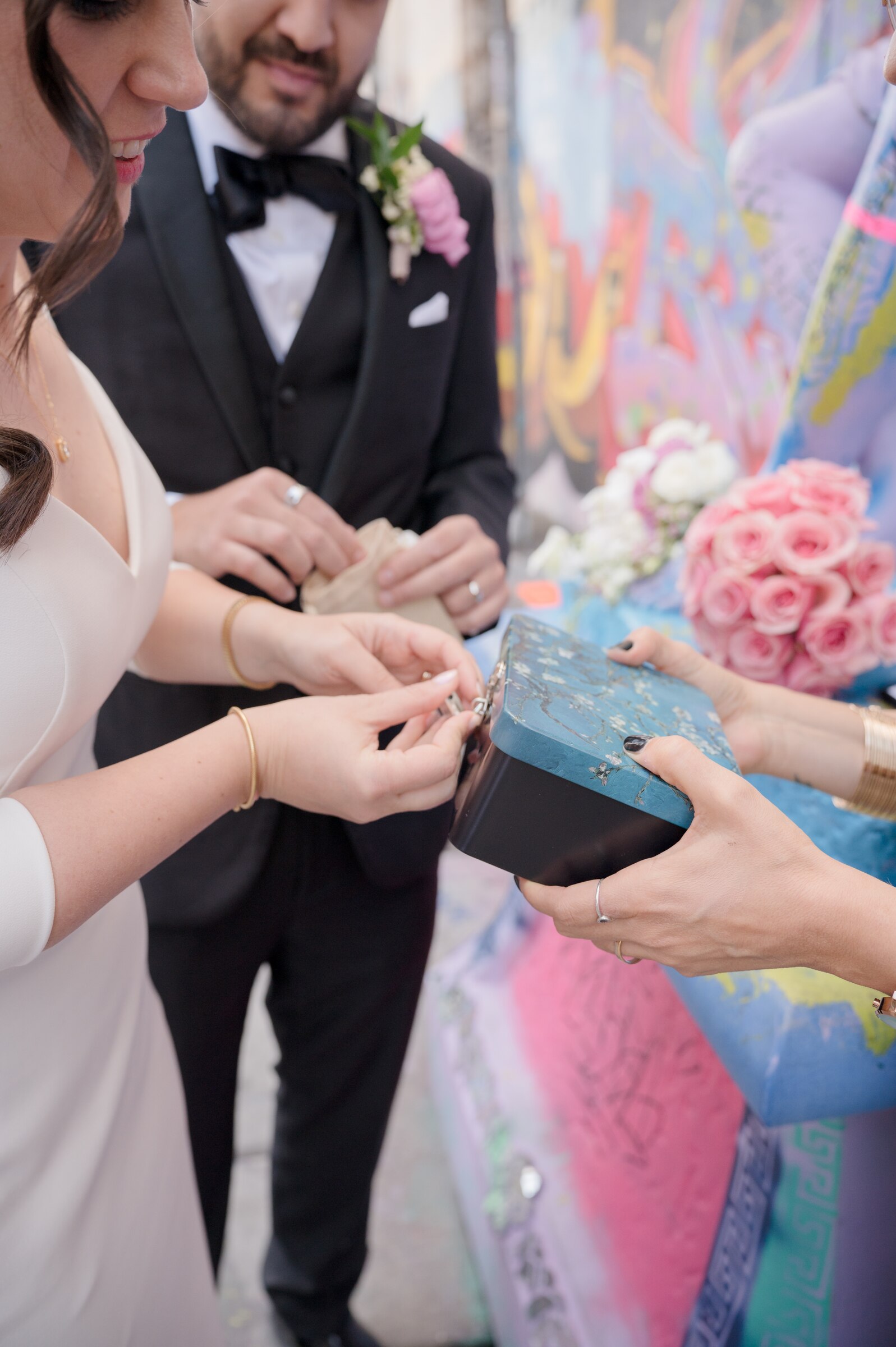 Couple placing keepsakes into a time capsule ceremony box