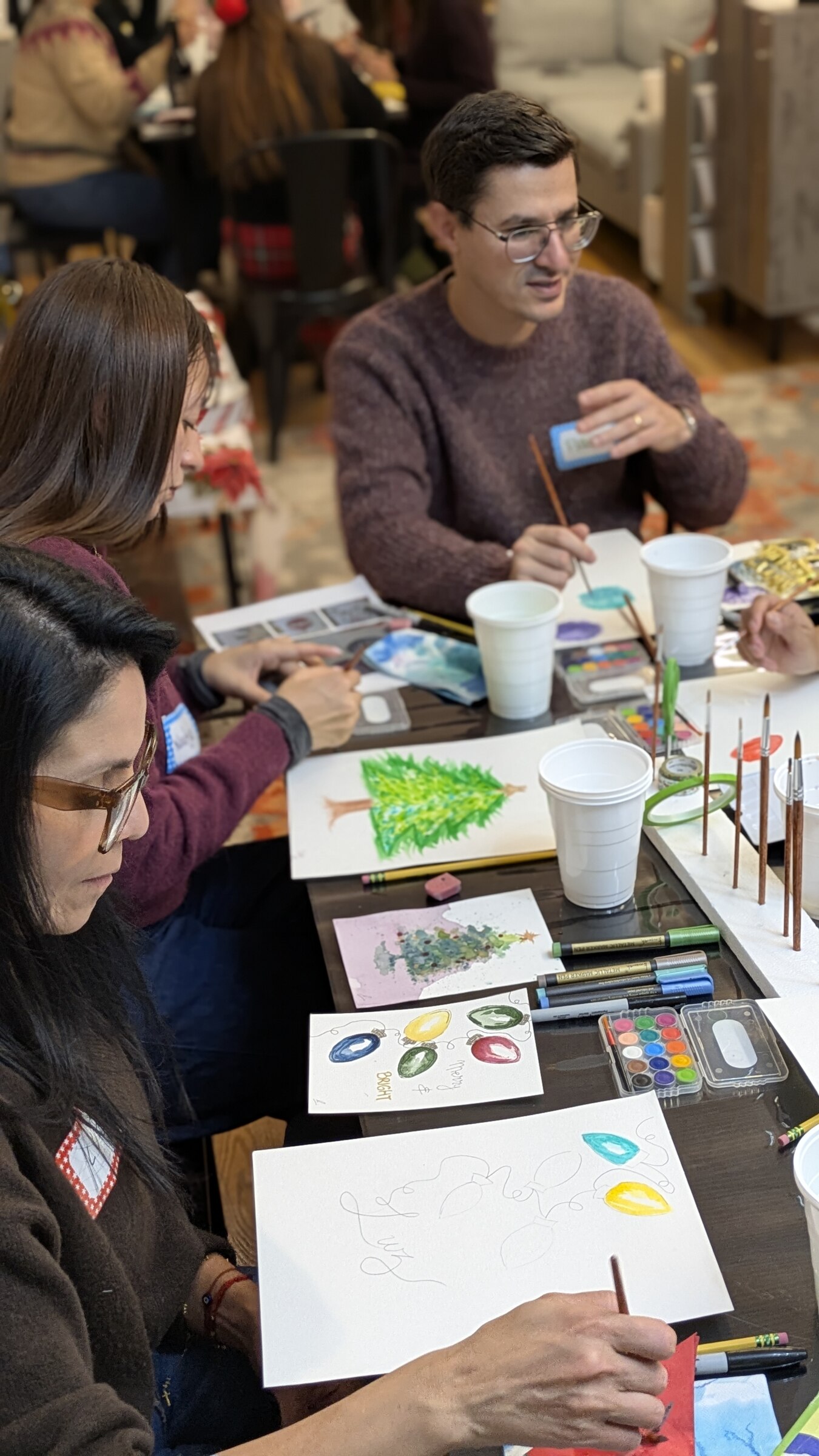 Guests painting together at a watercolor workshop